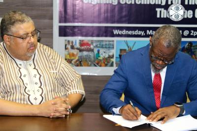 CBL Executive Governor Tarlue, Jr. signs the Participating Agreements (PAs) with three (3) Financial Institutions regarding the implementation of the Line of Credit (LOC) under the Liberia Investment Finance and Trade (LIFT-P) Project as Commerce Minister Modad looks on